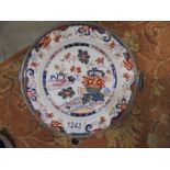 A 19th century signed Chinese Imari heated plate with pewter casing, 24 cm diameter.