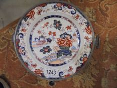 A 19th century signed Chinese Imari heated plate with pewter casing, 24 cm diameter.