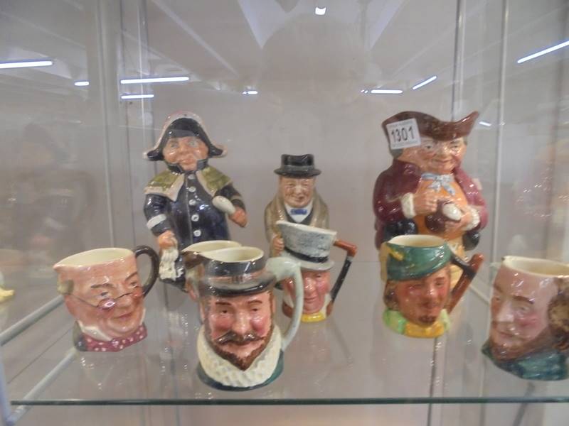 Six small Doulton character jugs, Doulton Churchill jug, Doulton Toby jugand Wedgwood town crier jug