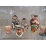 Six small Doulton character jugs, Doulton Churchill jug, Doulton Toby jugand Wedgwood town crier jug