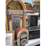 A large jukebox with radio, tape and cd, cd does not work, also a smaller jukebox radio and 2