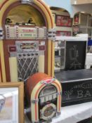 A large jukebox with radio, tape and cd, cd does not work, also a smaller jukebox radio and 2