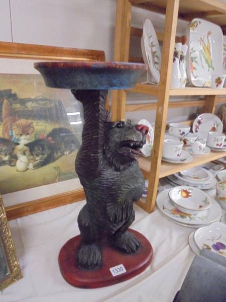 A carved wood Black Forest Bear plant stand, 53.5 cm tall, COLLECT ONLY.