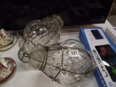 A pair of wire bound blown glass lanterns, approximately 40 cm drop.