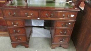 A mahogany kneehole desk. COLLECT ONLY.