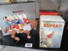 A boxed Royal Doulton Rupert figure "Hitching a Ride" and a boxed Rupert money box