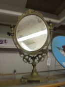 A brass framed swivel mirror.