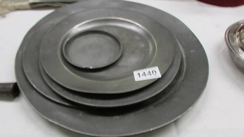 Five old pewter plates.