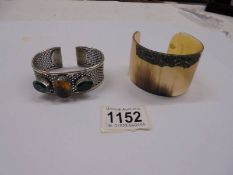 Two vintage cuff bangles, one in horn, the other stone set in silver.