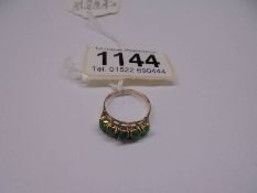 A five stone ring set with green stones in a claw setting stamped 14ct gold, size L half, 1.85 grams