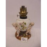 A Victorian cherub oil lamp with crossed swords makers mark.