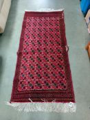 An old red wool rug, 61cm x 140cm COLLECT ONLY