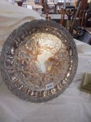 A decorative silver plate on copper drinks tray.
