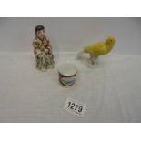 An antique Chinese figure (damage to sleeves) A porcelain canary (chip to beak) & a miniature mug.