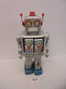 A vintage tinplate Japanese battery operated walking/shooting robot, working when tested, 31 cm tall