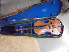 An old cased violin with bow.