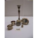 A silver candlestick, silver photo frames, 3 silver napkin rings and a silver thimble.