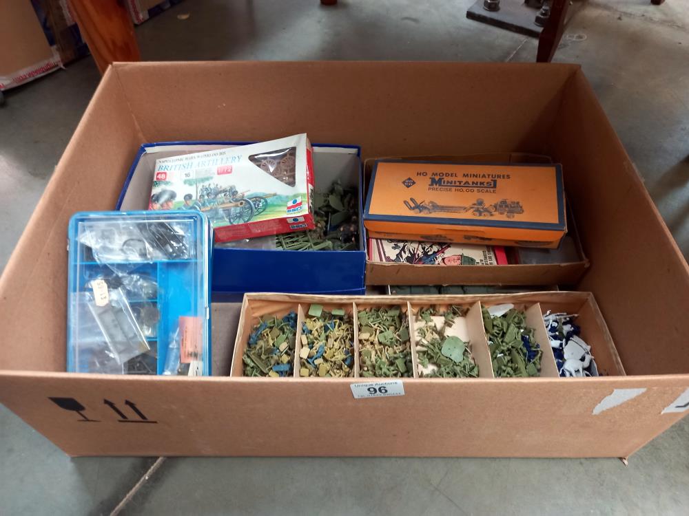 A large box of plastic soldiers and military vehicles