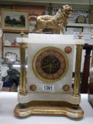 An alabaster and brass mantel clock surmounted lion, COLLECT ONLY.