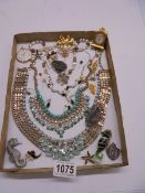 A mixed lot of costume necklaces, brooches etc.,