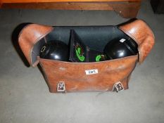 A set of four Thomas Taylor Lignoid lawn bowls in bag. COLLECT ONLY.
