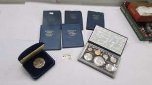 A 1976 New Zealand proof set, 1977 silver proof coin and five first decimal sets.