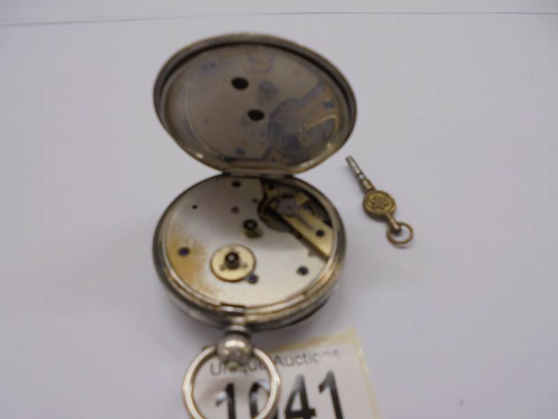 A silver pocket watch with key, in working order. - Image 3 of 3
