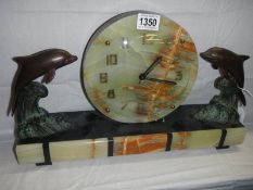 A French Art Deco marble mantel clock featuring dolphins, COLLECT ONLY.