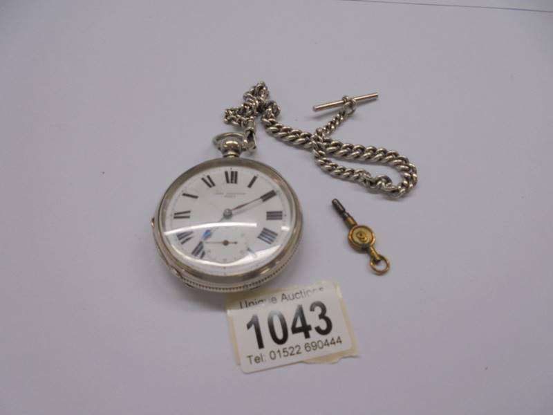 A silver pocket watch, John Jenkinson 40425 on silver Albert chain with key, in working order.