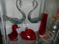 Two glass swan dishes and three pieces of red glass.