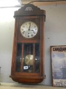 A 1930's oak wall clock. COLLECT ONLY.