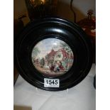 A framed Pratt ware pot lid.