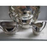 A three piece silver plate tea set.