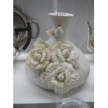 A Parian style ceramic vase with applied flowers.
