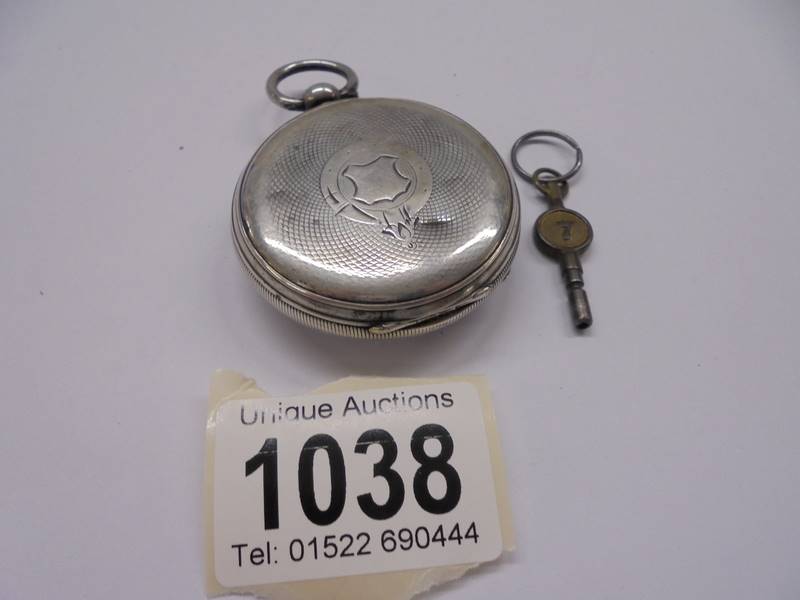 A silver pocket watch with key, in working order. - Image 2 of 2