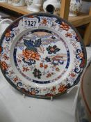 A 19th century Chinese Imari heated plate with signed pewter casing, 24 cm diameter.