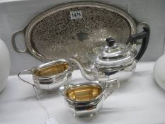 An oval silver plate tray together with a three piece silver plate tea set.