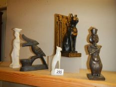 An Egyptian cat door stop and other ornaments.