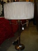 A two light brass table lamp with shade.