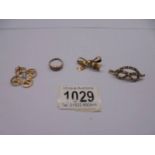 A 9ct gold bow brooch 2.1g, a 9ct gold ring 1.3g (missing 1 stone), a yellow metal brooch