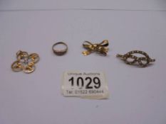 A 9ct gold bow brooch 2.1g, a 9ct gold ring 1.3g (missing 1 stone), a yellow metal brooch