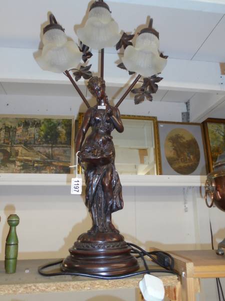 A tall figural three light table lamp with glass shades. COLLECT ONLY.
