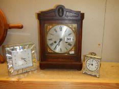 A 1930's mantel clock and two modern clocks.