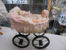 A Victorian style dolls pram with two dolls, COLLECT ONLY.