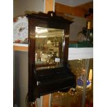 A wood framed wall mirror with candle box. COLLECT ONLY.