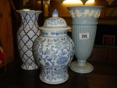 A Wedgwood glazed embossed Queensware vase and one other.