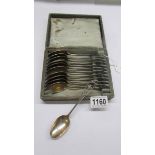 A cased set of plated teaspoons featuring a coat of arms.