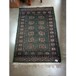 An old green wool rug, 80cm x 135cm COLLECT ONLY