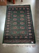 An old green wool rug, 80cm x 135cm COLLECT ONLY