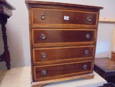 A mahogany inlaid four drawer chest. COLLECT ONLY.